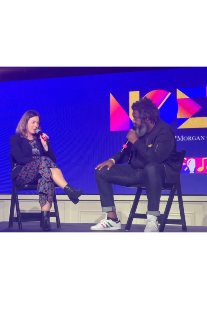 Lisa LaCour on stage, hosting a conversation at New Orleans Entrepreneur Week