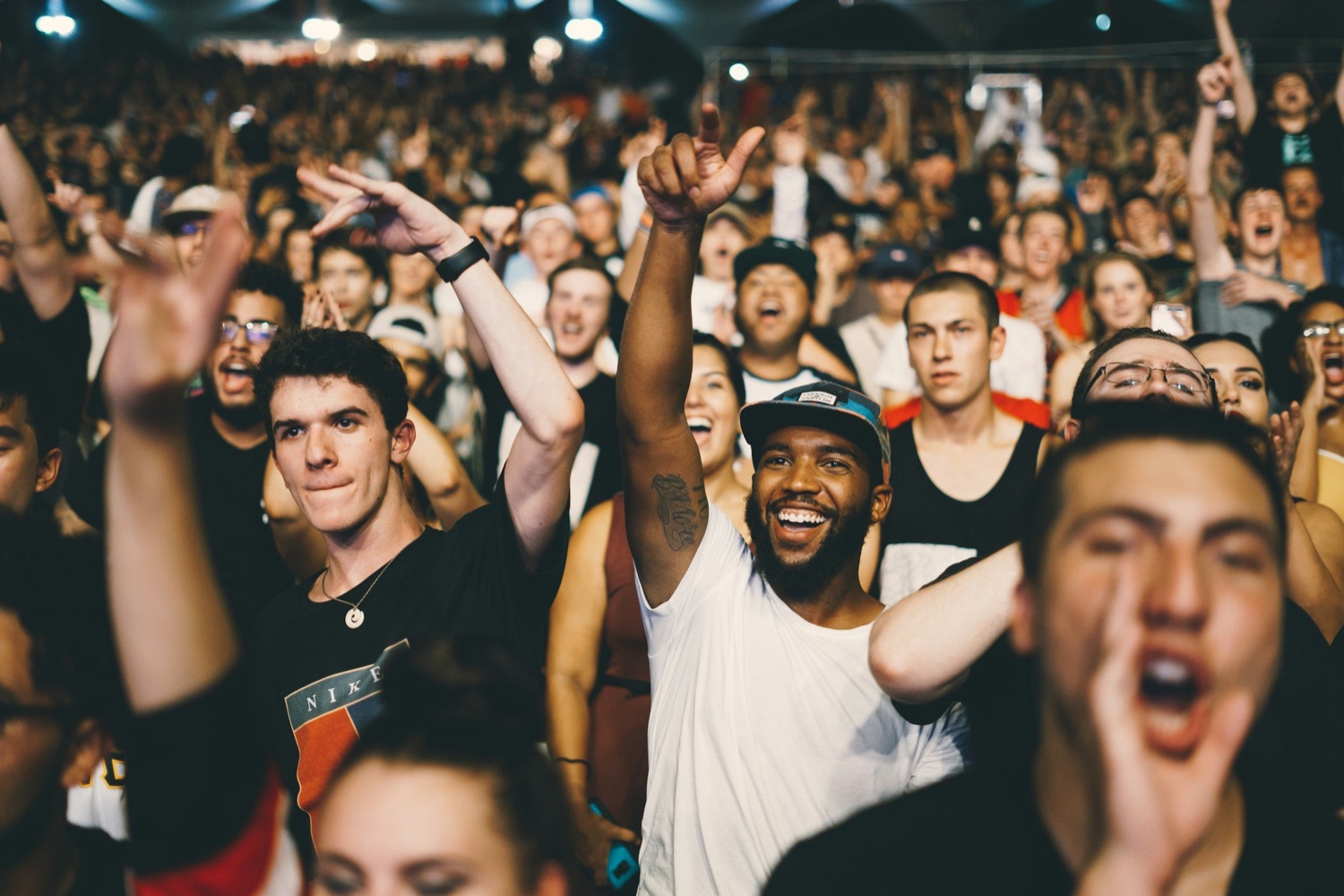 An energized crowd cheering at a concert